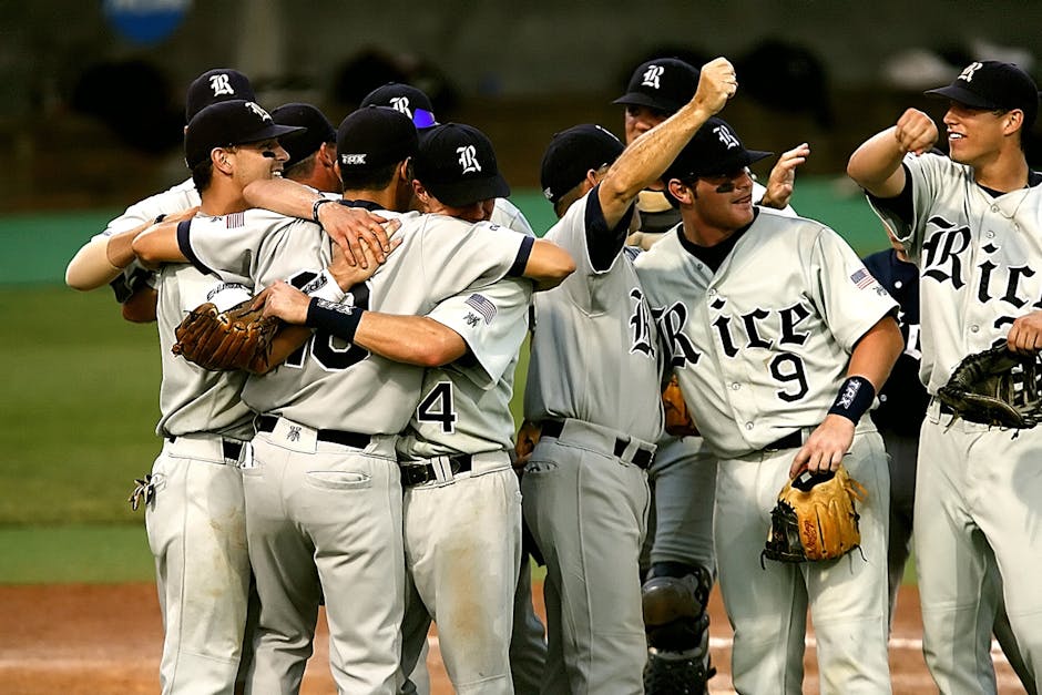 Baseball team celebrating victory on a field, showcasing teamwork and joy.