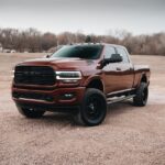 red chevrolet crew cab pickup truck on dirt road during daytime