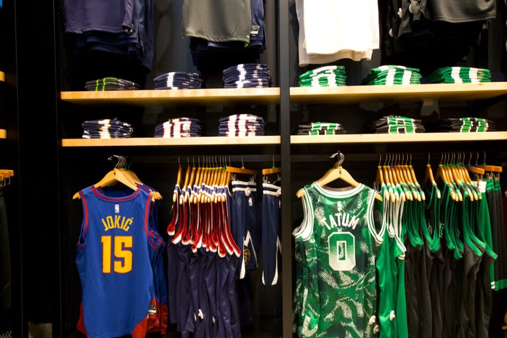 Basketball jerseys and apparel displayed on shelves and racks.