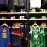 Basketball jerseys and apparel displayed on shelves and racks.