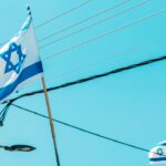 the israeli flag is flying on a pole
