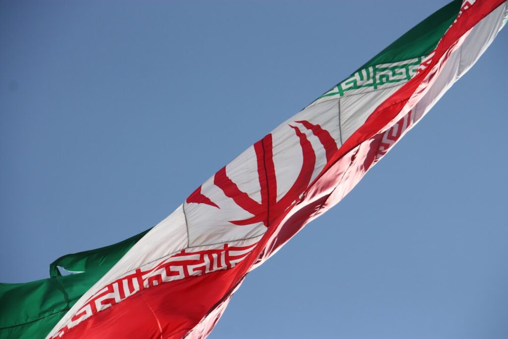 Islamic republic of Iran flag, waving over Chitgar park, lighted by evening sun. اهتزاز پرچم ایران در ارتفاعات پارک چیتگ