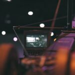 black laptop computer turned on on the stage