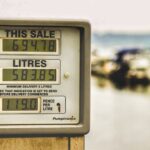 Blurred background view with focus on fuel pump display showing price and liters.