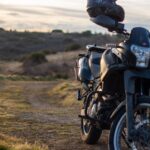 black motorcycle on brown field during daytime