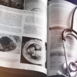 a medical book with a stethoscope on top of it