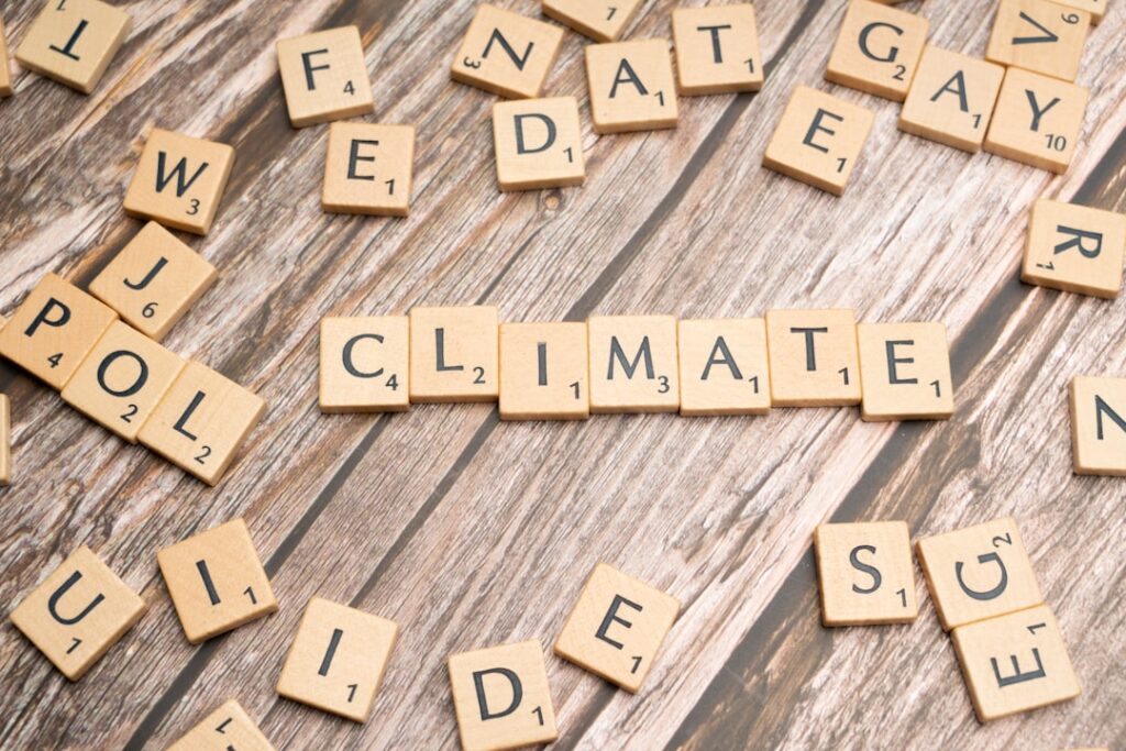 scrabble tiles spelling climate on a wooden surface