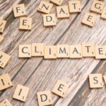 scrabble tiles spelling climate on a wooden surface