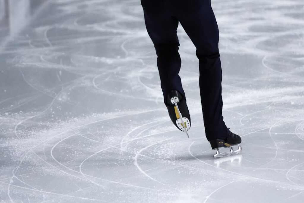 a man is skating on an ice rink