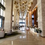 a hotel lobby with a chandelier hanging from the ceiling