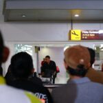 waiting for someone at the airport arrivals terminal.