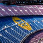 a sports arena with a field and seating