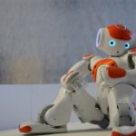 A dancing robot is resting and watching others