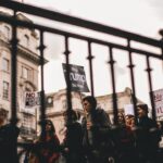 people walking with signs at the city during day