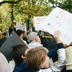People holding signs at an outdoor rally