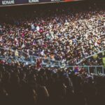 A crowded soccer stadium packed with enthusiastic fans during a match.