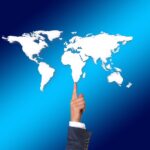 balance, balancing act, finger, businessman, world, earth, globe, politician, power, power games, continents, politics,