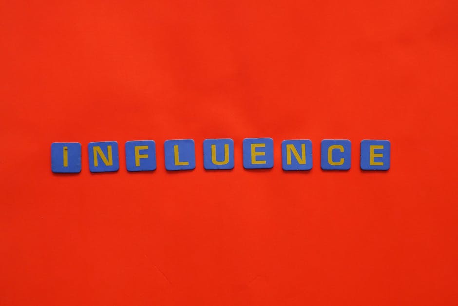 Bold blue letters spelling 'Influence' on a vibrant red background, conveying impact.