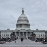 A grand shot of the United States Capitol in Washington D.C. with visitors in the foreground.