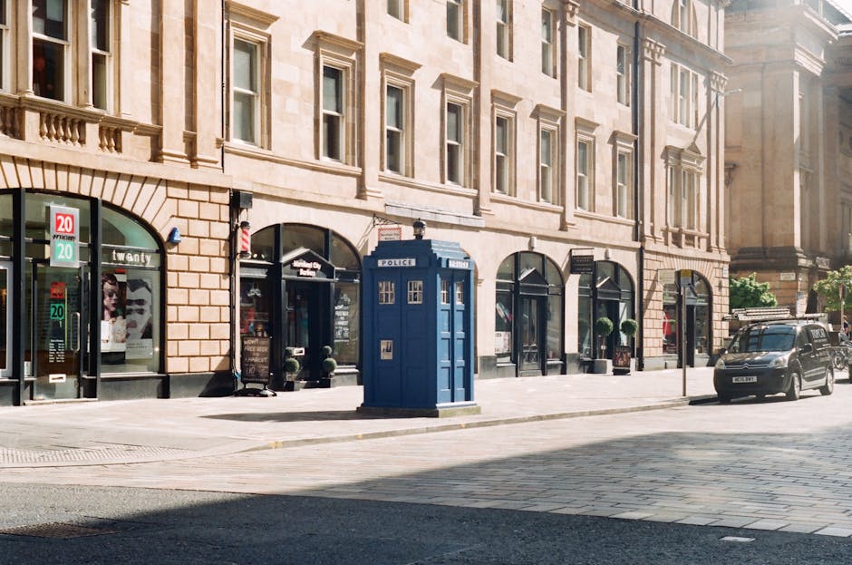 Charming city street scene featuring a distinctive blue police box amidst urban architecture.