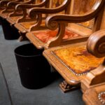 Detailed view of ornate wooden seats inside Bern's parliament building, showcasing craftsmanship.