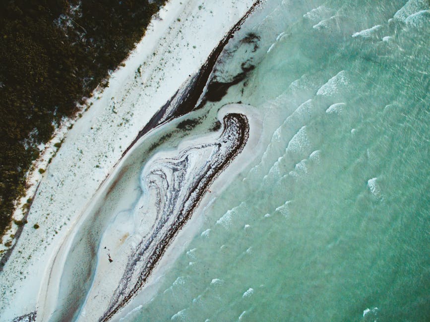 A breathtaking aerial view of a tranquil beach in Yucatan, Mexico with azure waters and white sand.
