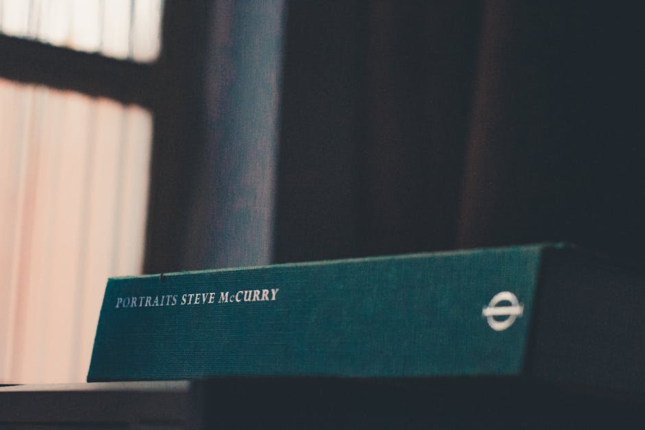A tranquil indoor scene featuring a Steve McCurry portrait book on a desk.