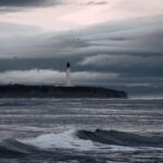 Dramatic seascape featuring Covesea Lighthouse at dusk in Lossiemouth, Scotland.