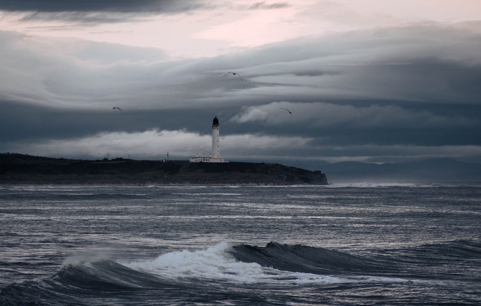 Dramatic seascape featuring Covesea Lighthouse at dusk in Lossiemouth, Scotland.