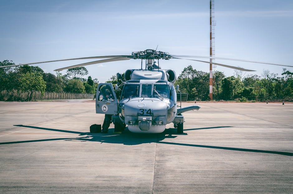 Military helicopter parked outdoors on a sunny day at a Brazilian airfield.