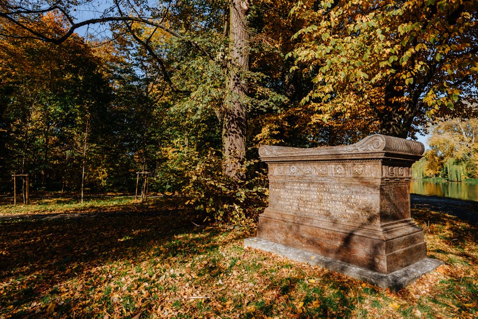 Sarcophagus surrounded by autumn foliage in Warsaw's Wilanow Park.