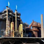 A view of the historic Völklingen Ironworks industrial facility under a clear blue sky.