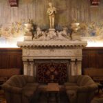Luxurious hotel lounge in Luso, Portugal featuring a grand fireplace and opulent decor.