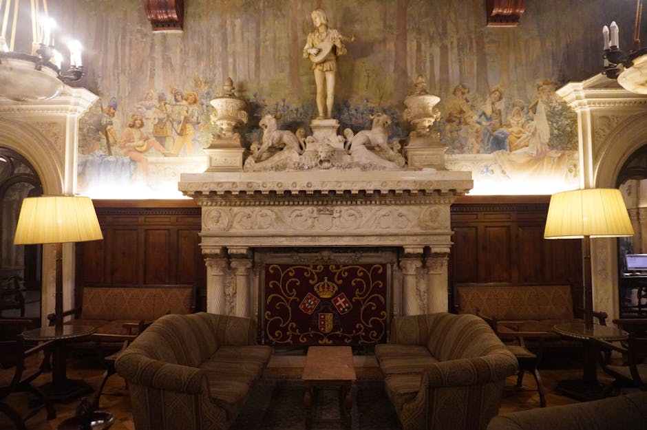 Luxurious hotel lounge in Luso, Portugal featuring a grand fireplace and opulent decor.
