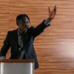 A passionate politician delivering a speech at a podium indoors.