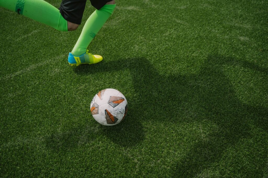 A soccer player about to kick a ball.