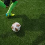 A soccer player about to kick a ball.