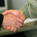 a close up of two people shaking hands