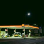 a gas station at night with a lit up gas station