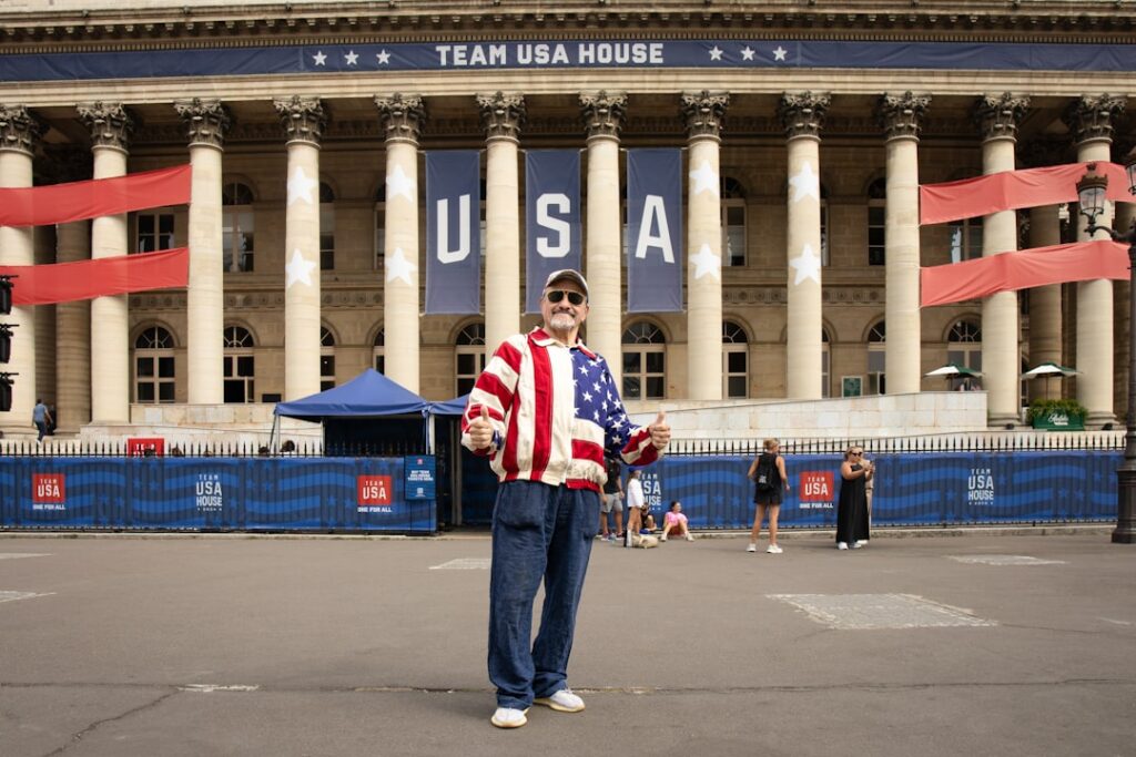 A man in USA patriotic outfit standing in front of building