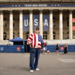 A man in USA patriotic outfit standing in front of building