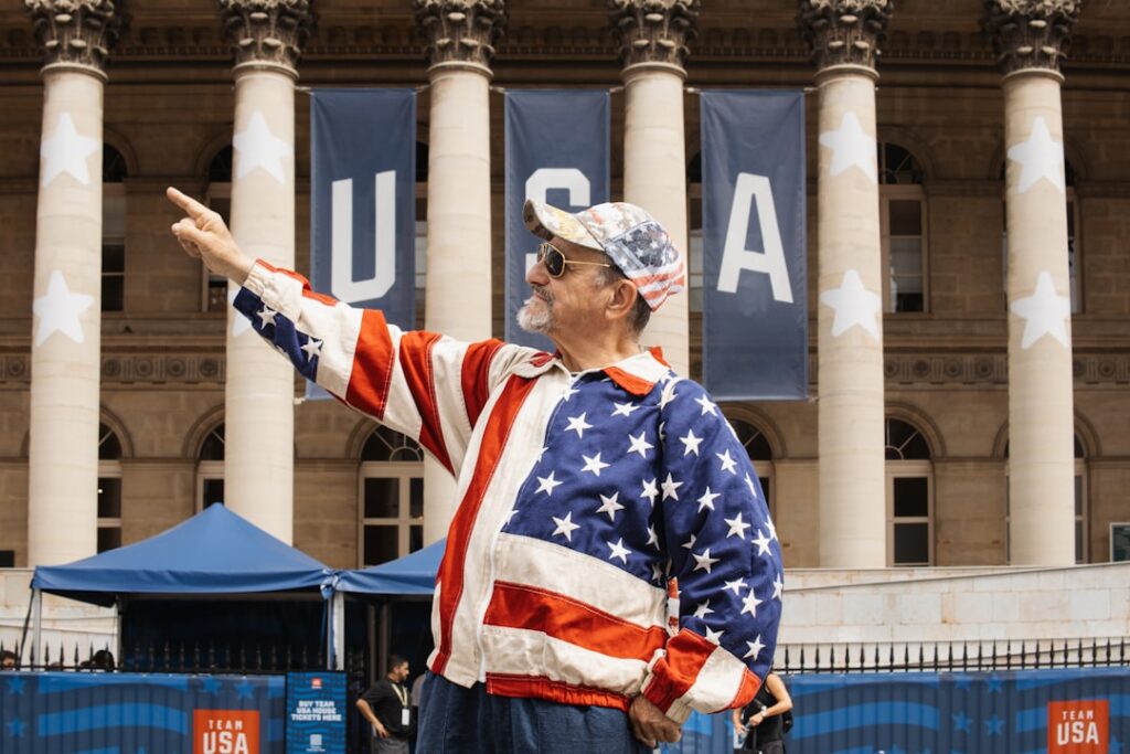 A man in USA patriotic outfit standing in front of building