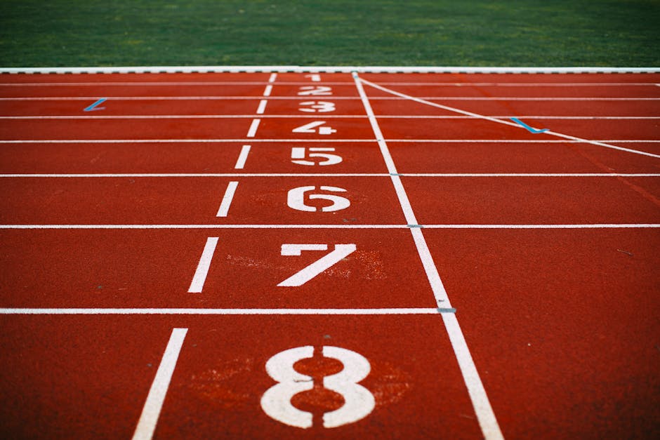 Close-up view of an athletic race track with numbered lanes, ready for competition.