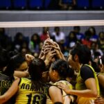 Female volleyball team huddles for a game in Quezon City, Philippines.