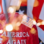 Close-up of a red cap with 'Make America Great Again' and a small American flag.