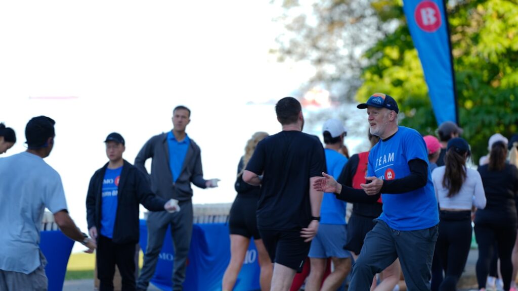 People gathered at an outdoor event with blue banners