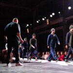 Models walking on a runway during a fashion show.