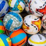 Vibrant collection of soccer balls with various patterns and colors.