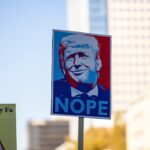 Protest sign with donald trump's face and "nope"