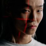 Close-up of an expressive face with facial recognition technology in a studio setting.